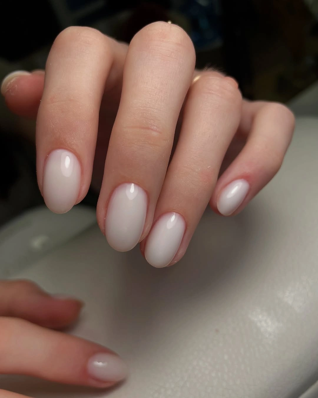 Short oval nails in glossy milky pink white polish