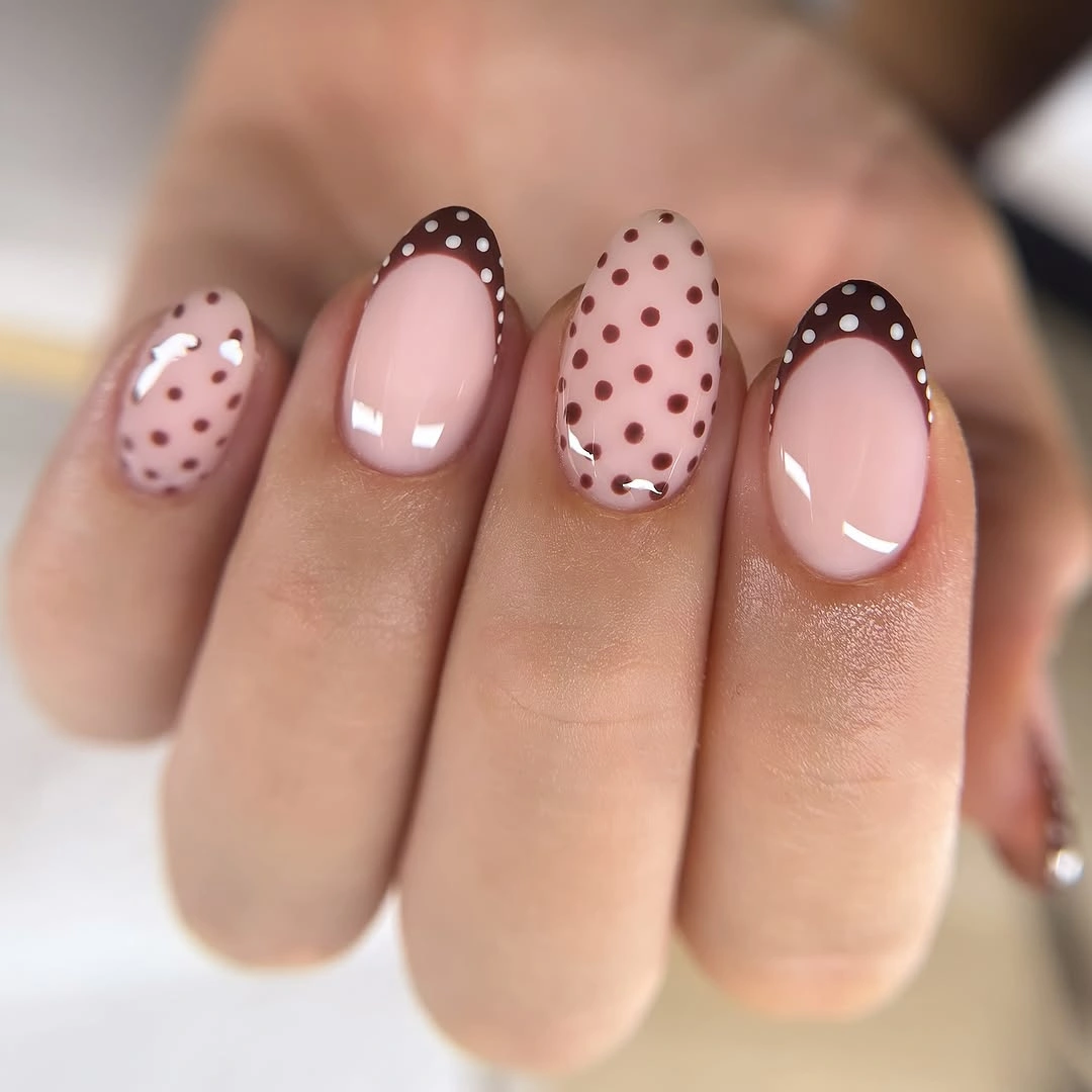 Blush oval nails with dark brown dots and dotted brown edge details