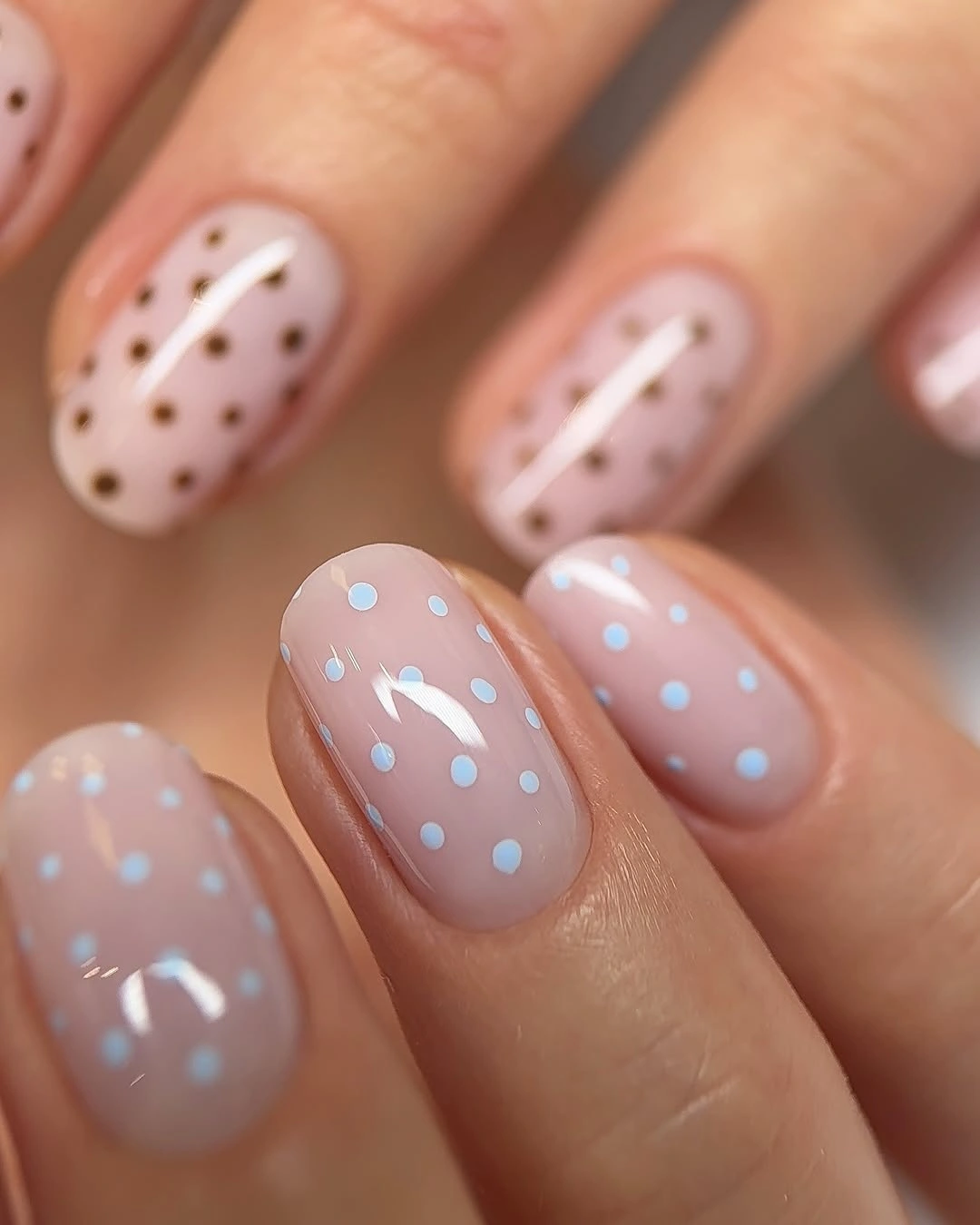 Short blush nails with pale blue and white dot accents