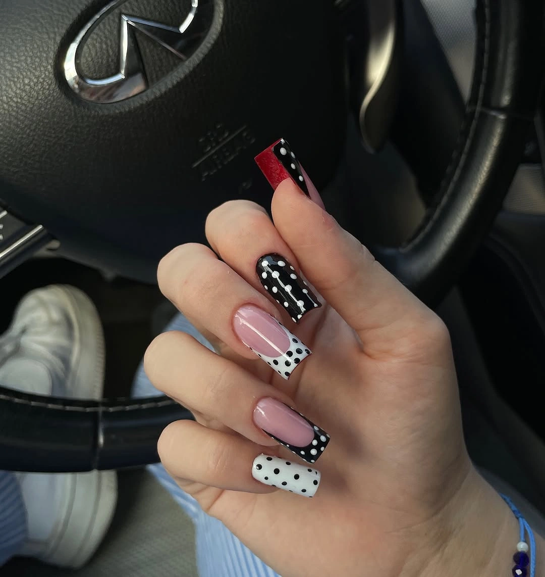 Black white pink and red square nails with mixed polka dot accents