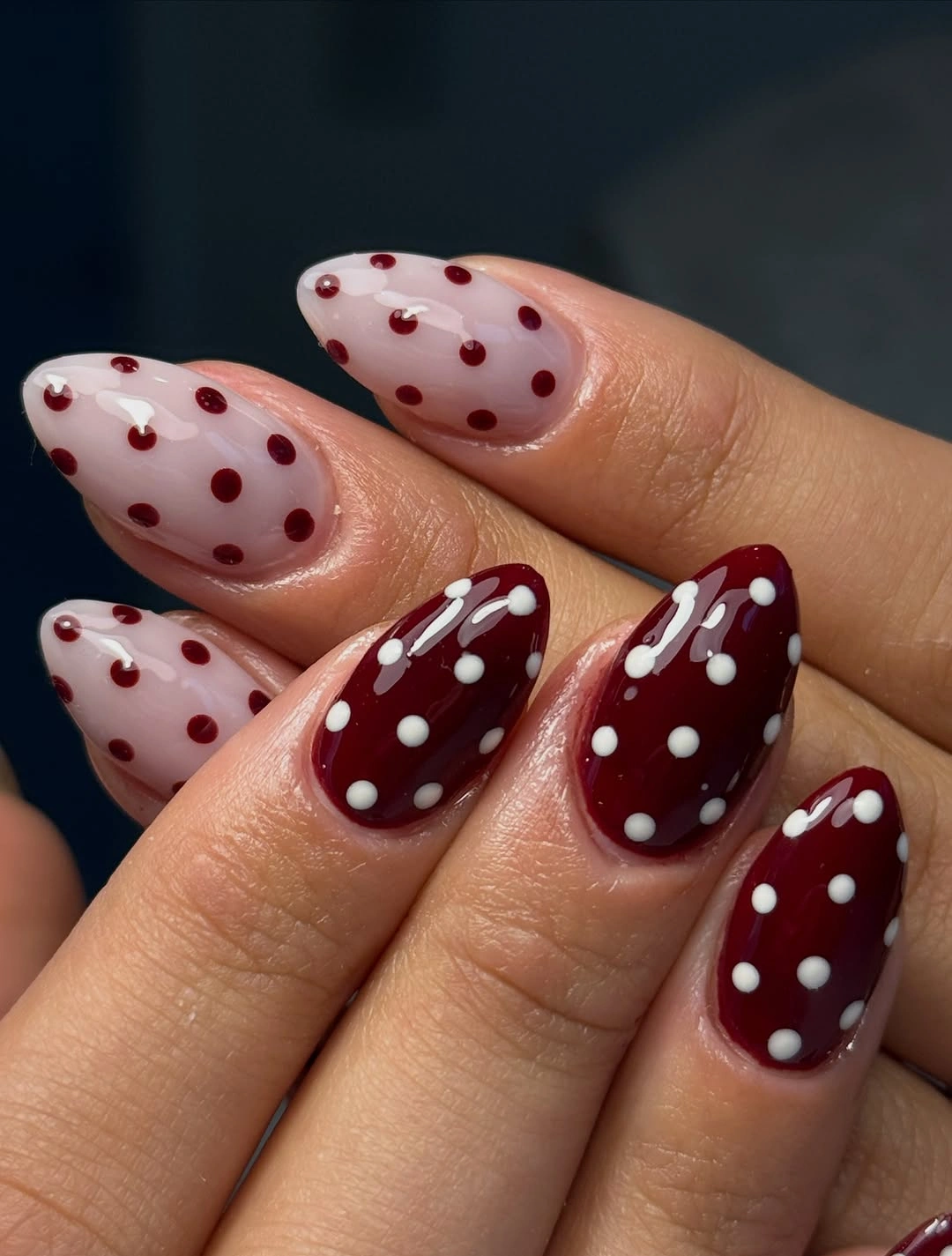 Blush and burgundy almond nails with reversed white and burgundy polka dots