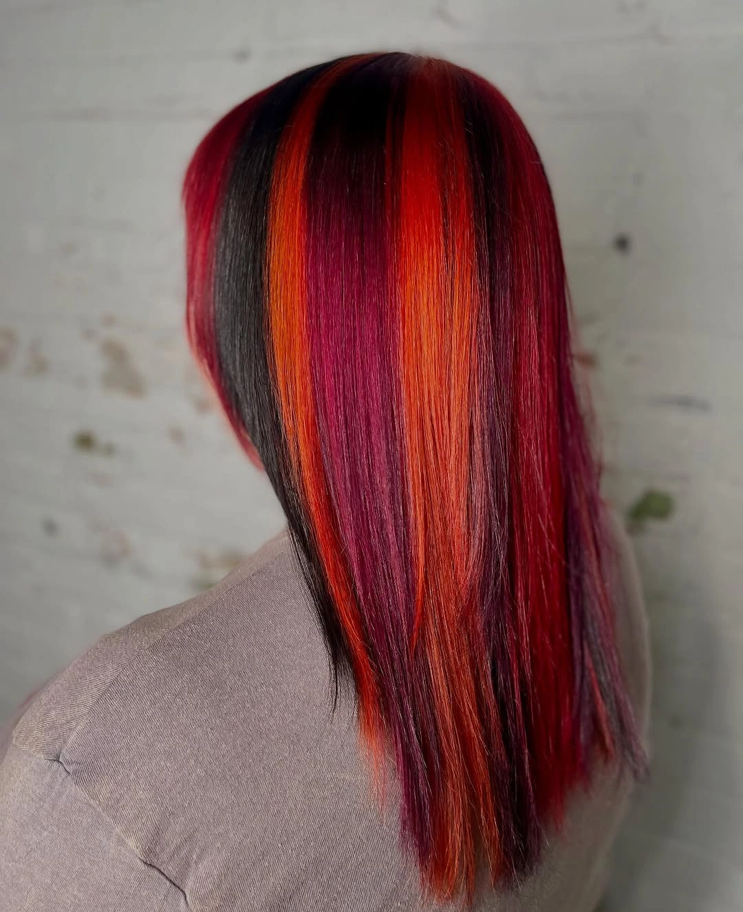 Long red hair with burgundy sides and vivid orange panels