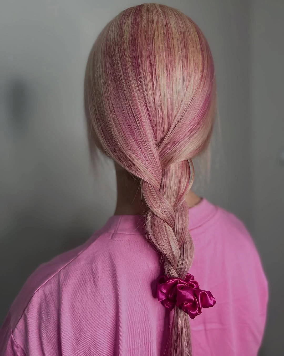 Pastel pink long braid finished with a deeper pink bow