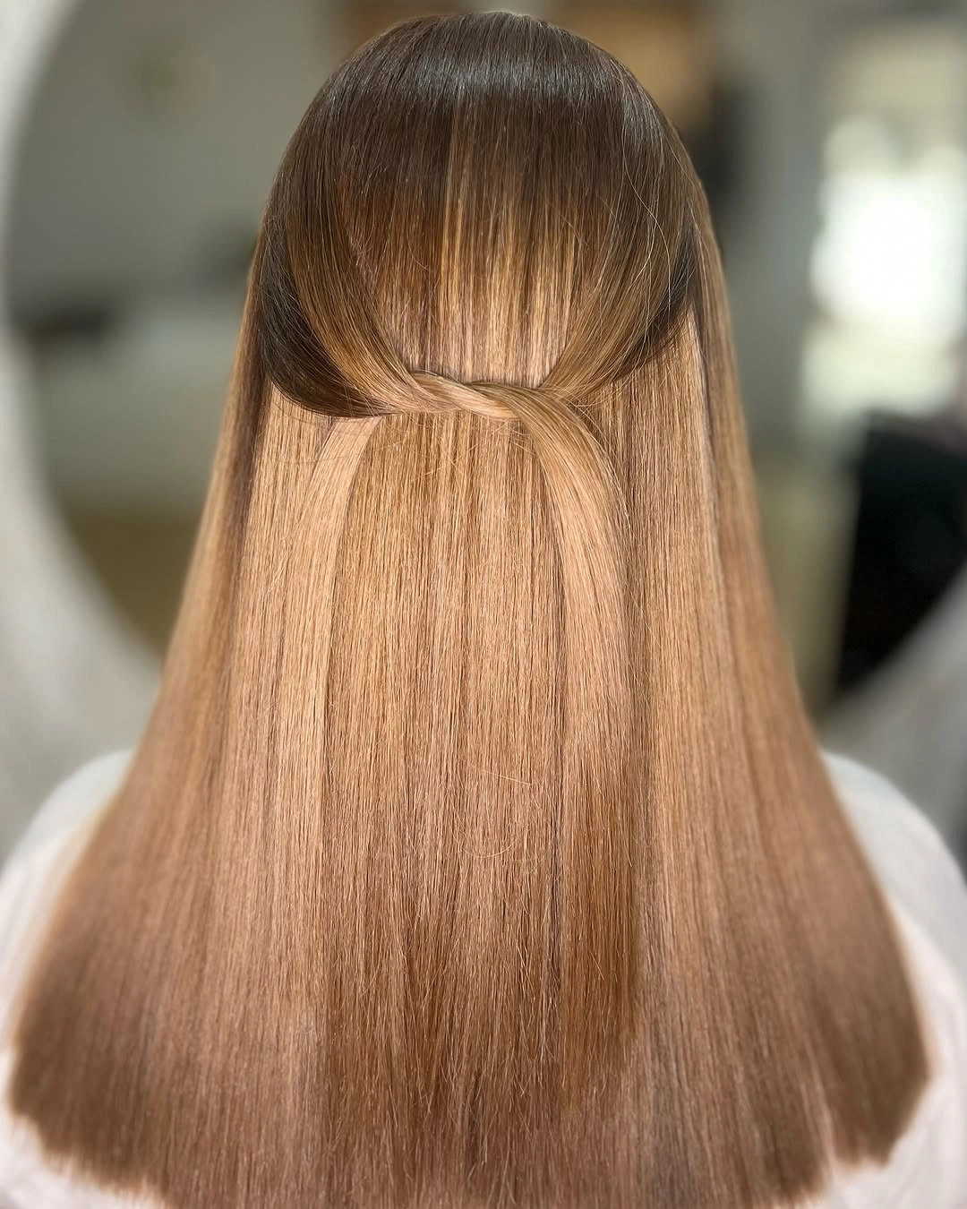 Straight honey beige hair with a clean half-up twist