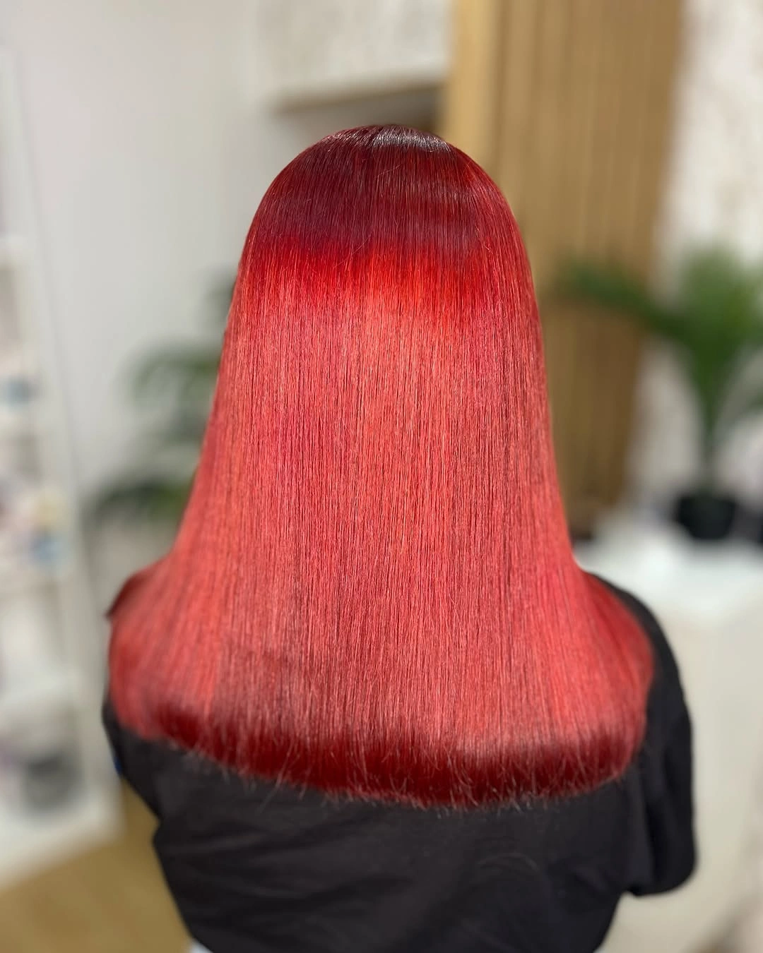 Blunt shoulder length red hair with a darker burgundy root
