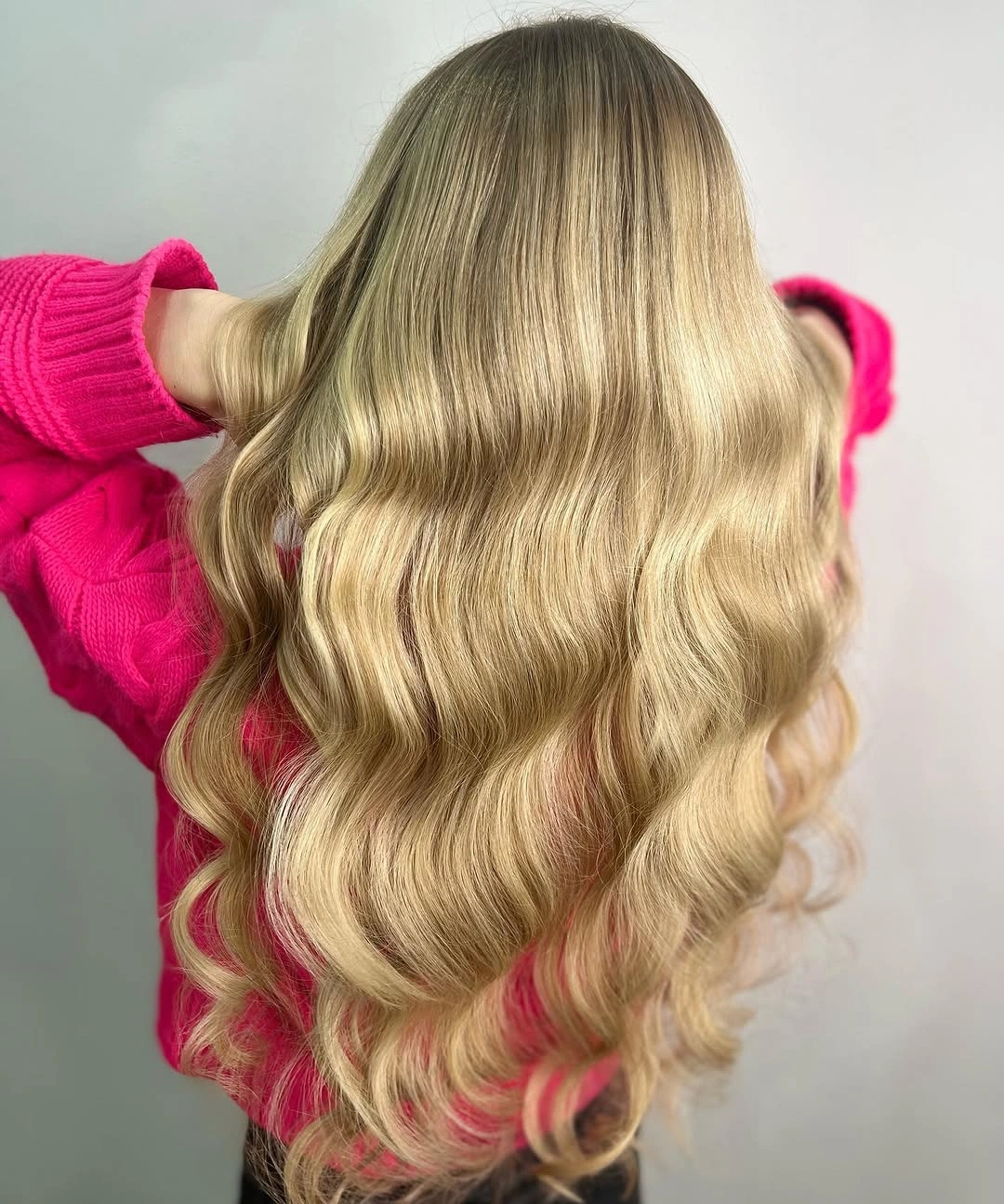 Long creamy blonde waves with a softly darker root