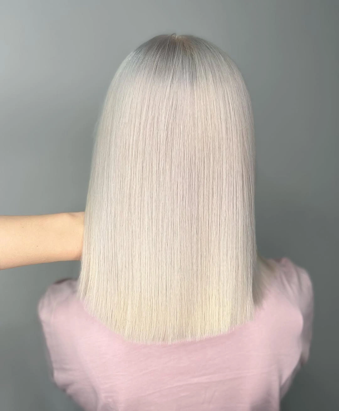Icy blonde straight hair with a blunt shoulder length hem