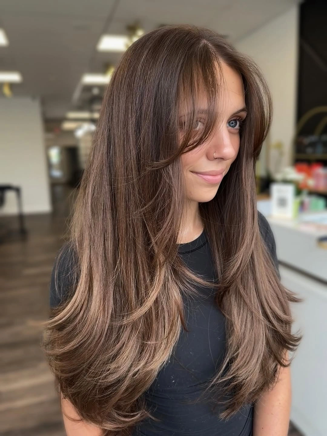 Long brunette hair with airy face framing and soft bends