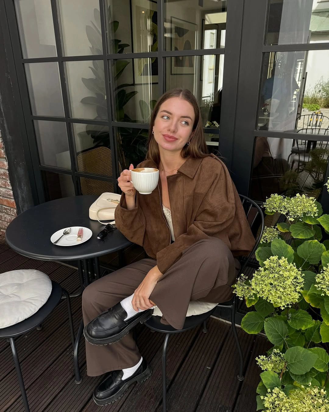 Brown jacket and trousers with white top and black loafers