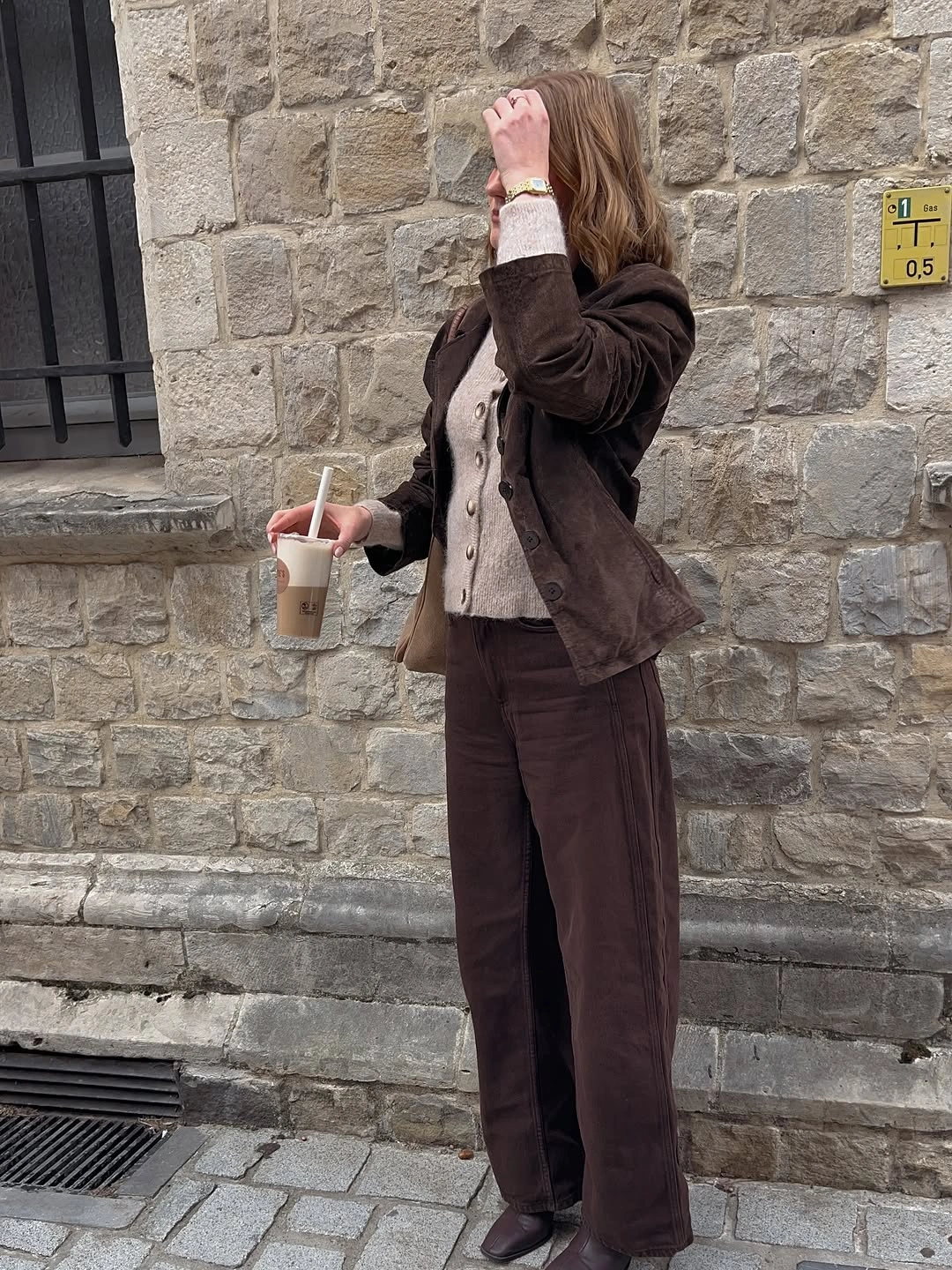 Layered brown jacket with taupe top and wide trousers
