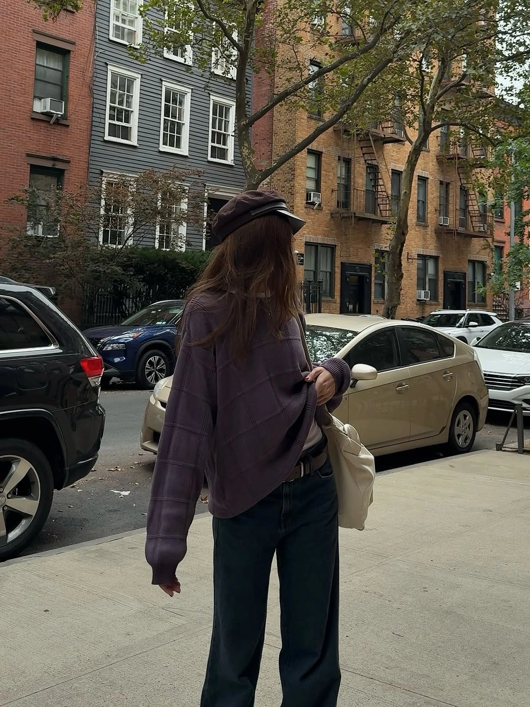 Dark oversized shirt jacket with wide trousers and white bag