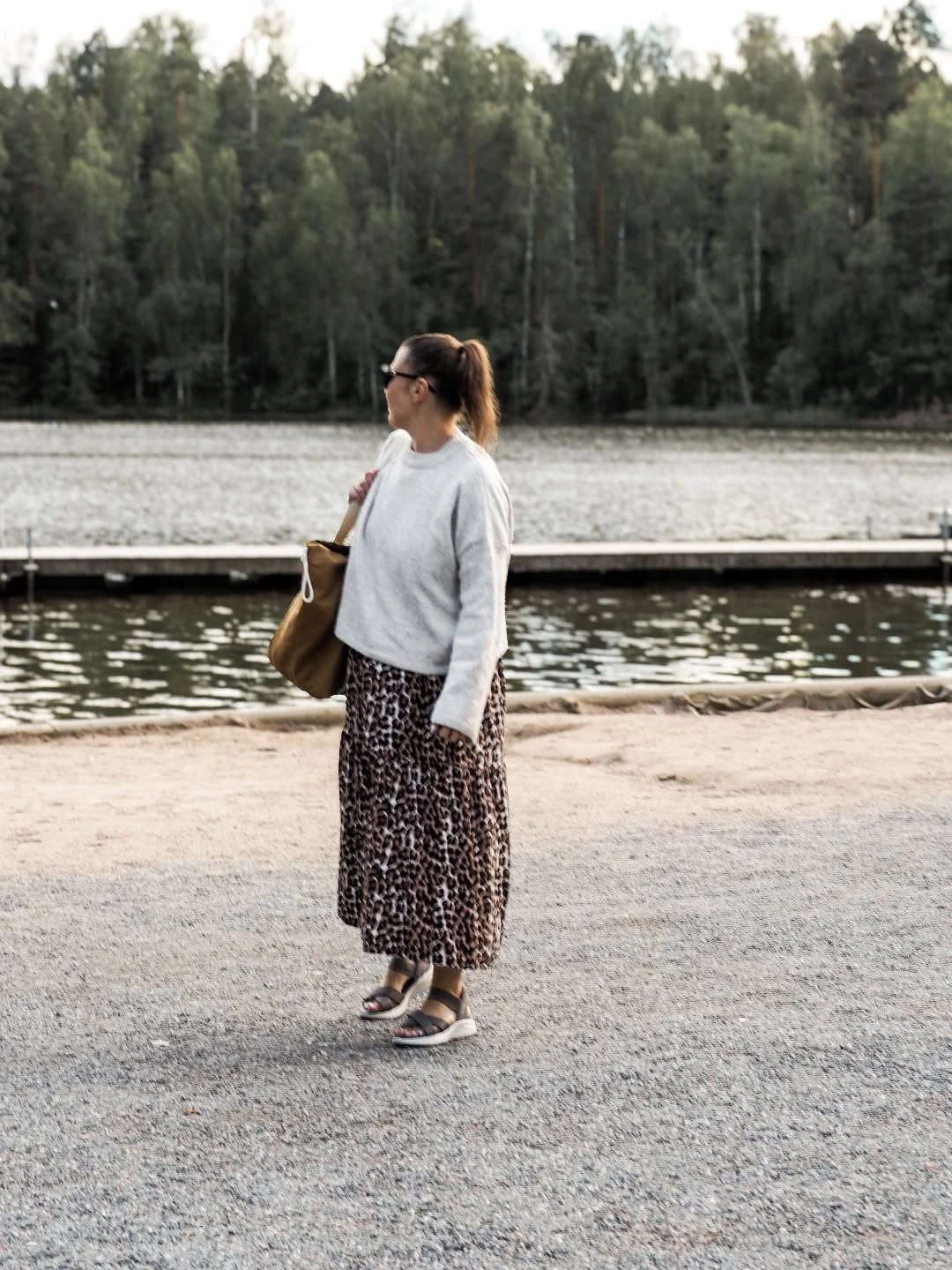 White sweater with leopard midi skirt and brown tote