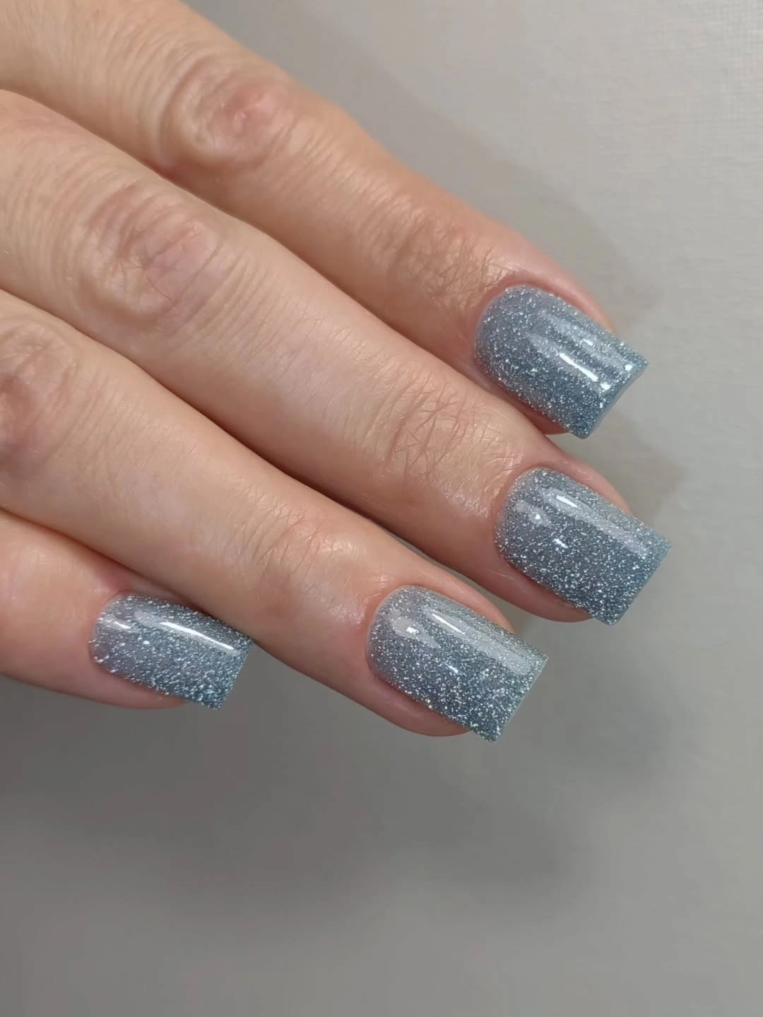 Silver glitter short square nails with fine reflective sparkle