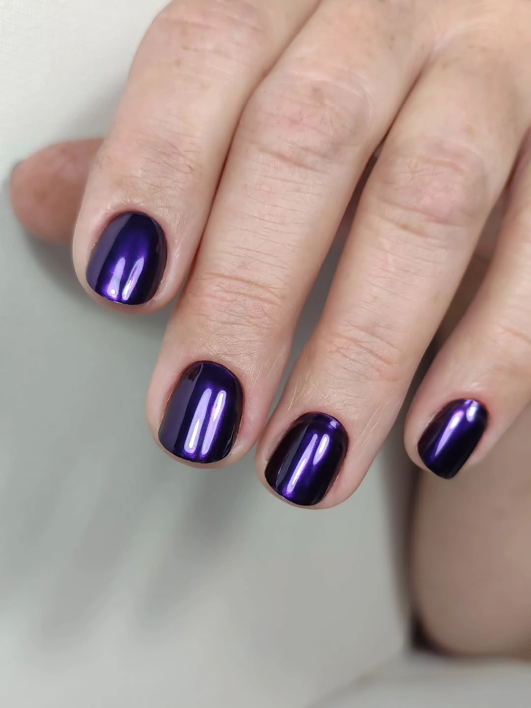 Deep purple short rounded-square nails with glossy shine