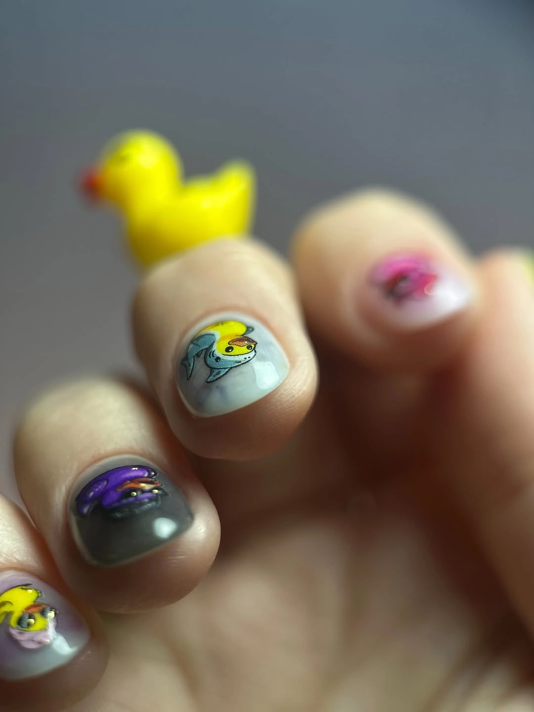 Pale blue gray short nails with tiny colorful illustrations