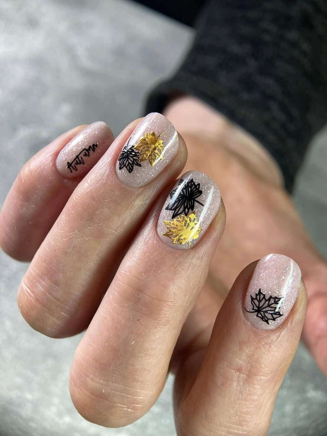 Milky short square nails with black botanical lines and yellow accents