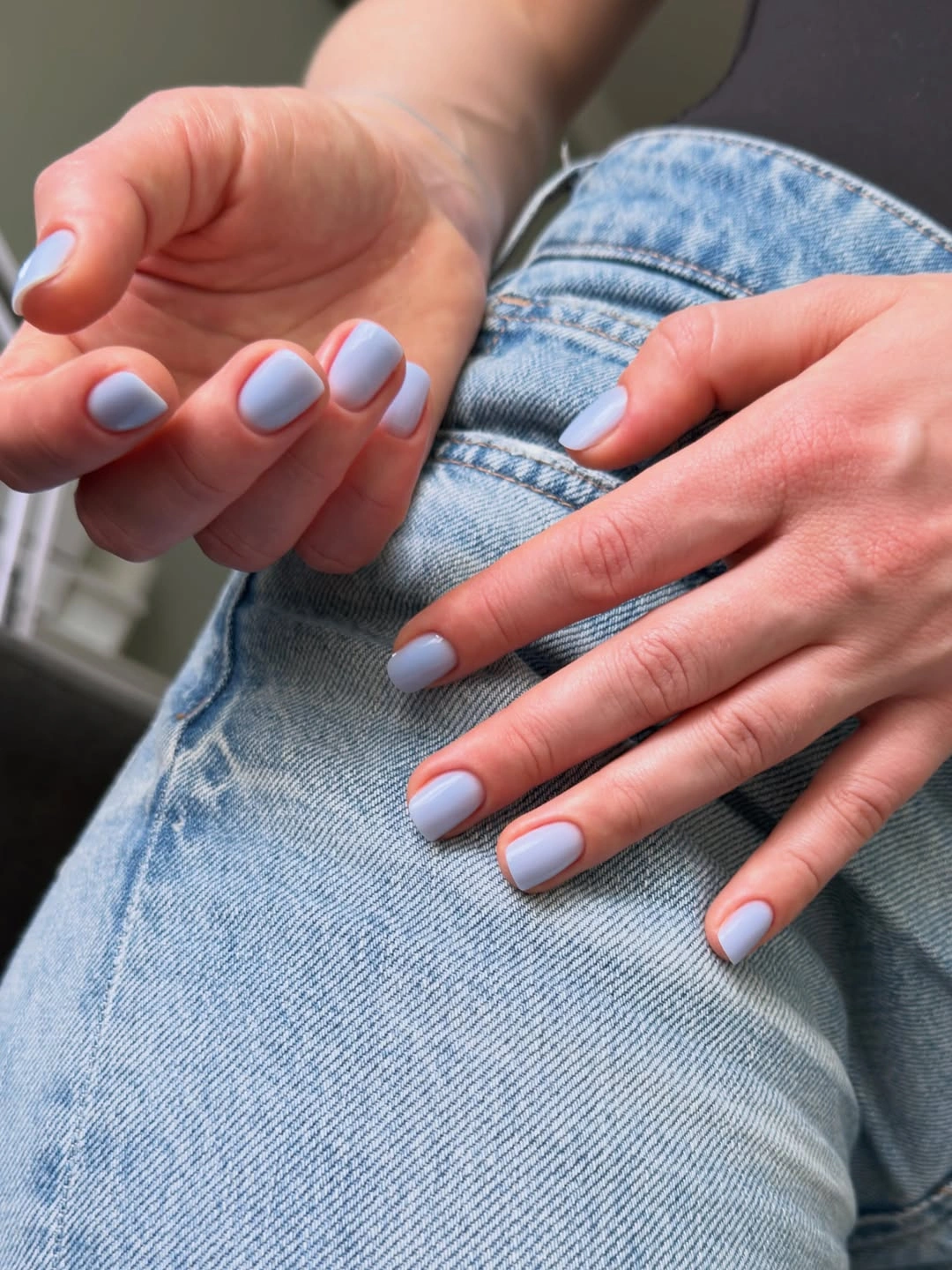 Pale blue short rounded-square nails over denim
