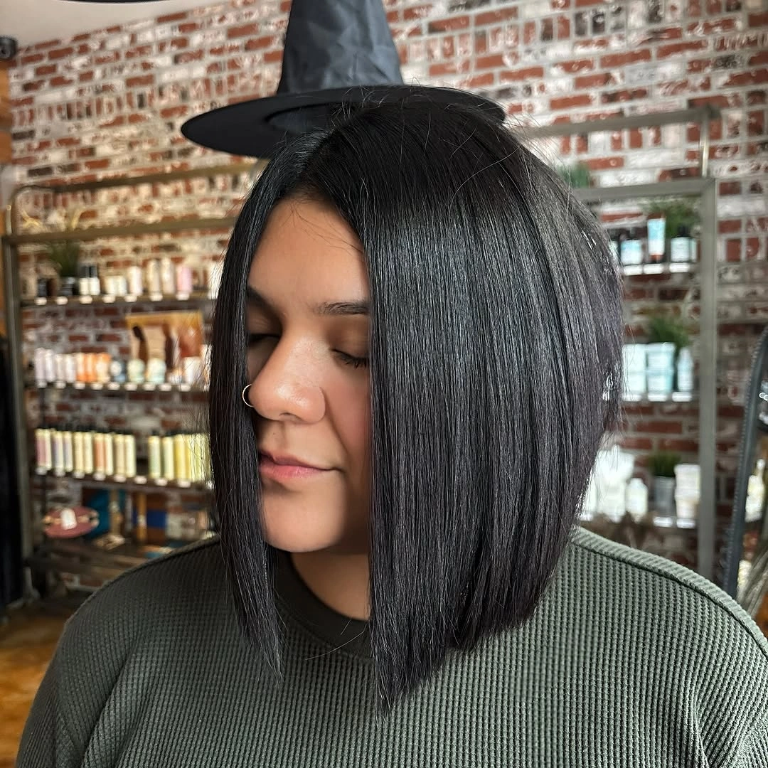 Glossy black bob with center part and blunt angled ends