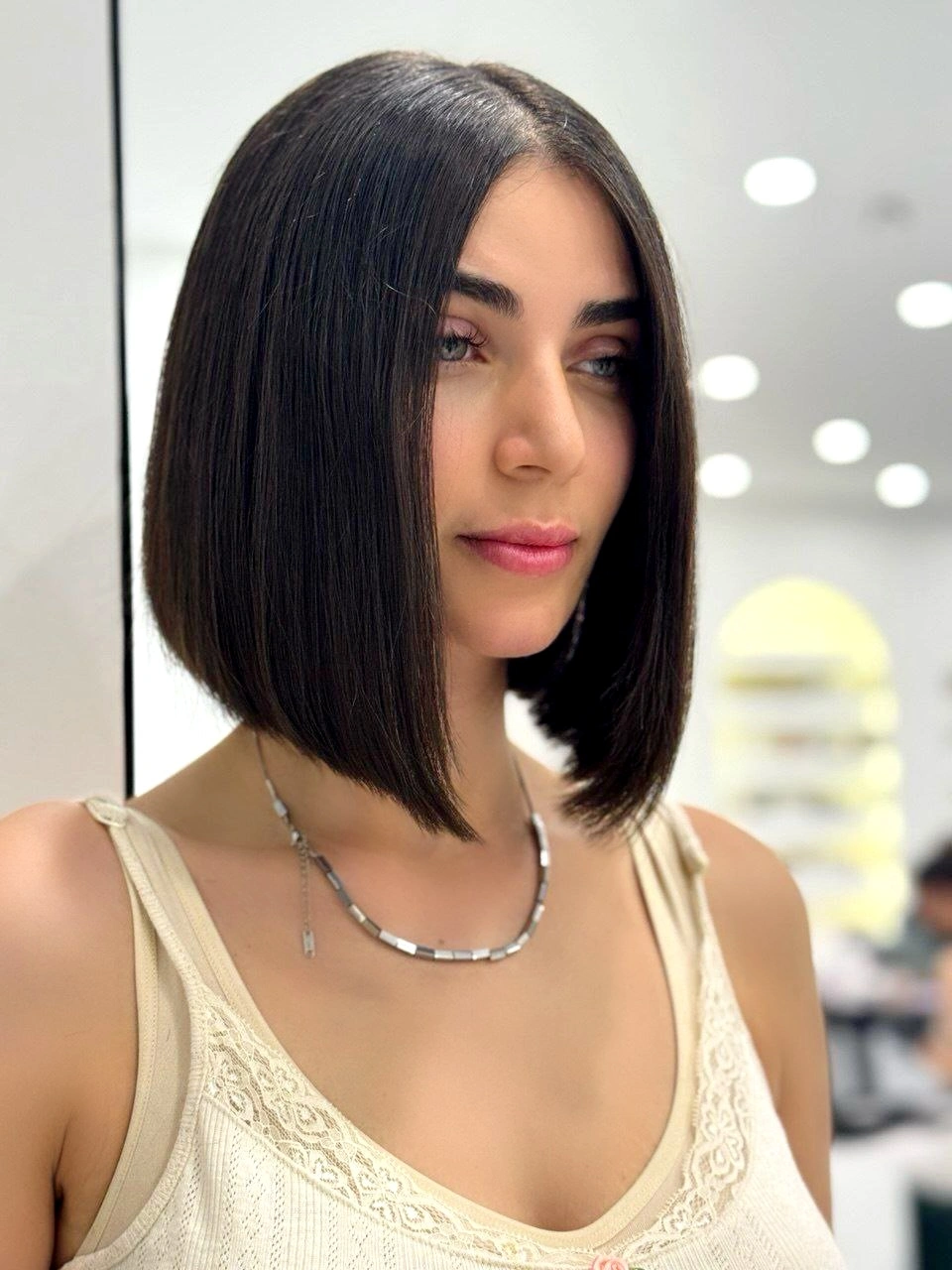 Sleek dark bob with center part and pointed front corners