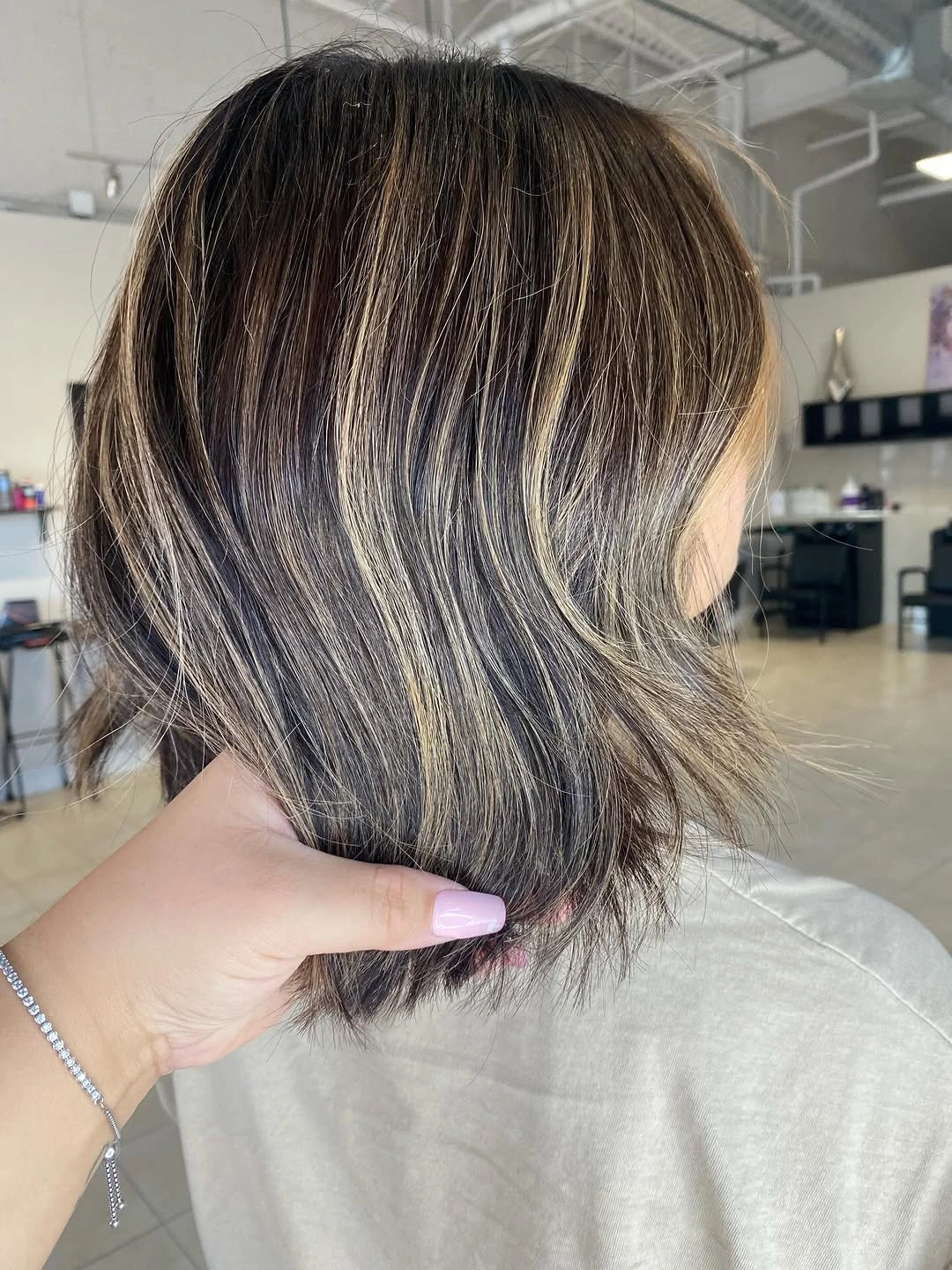 Dark wavy bob with blonde ribbons and piecey ends