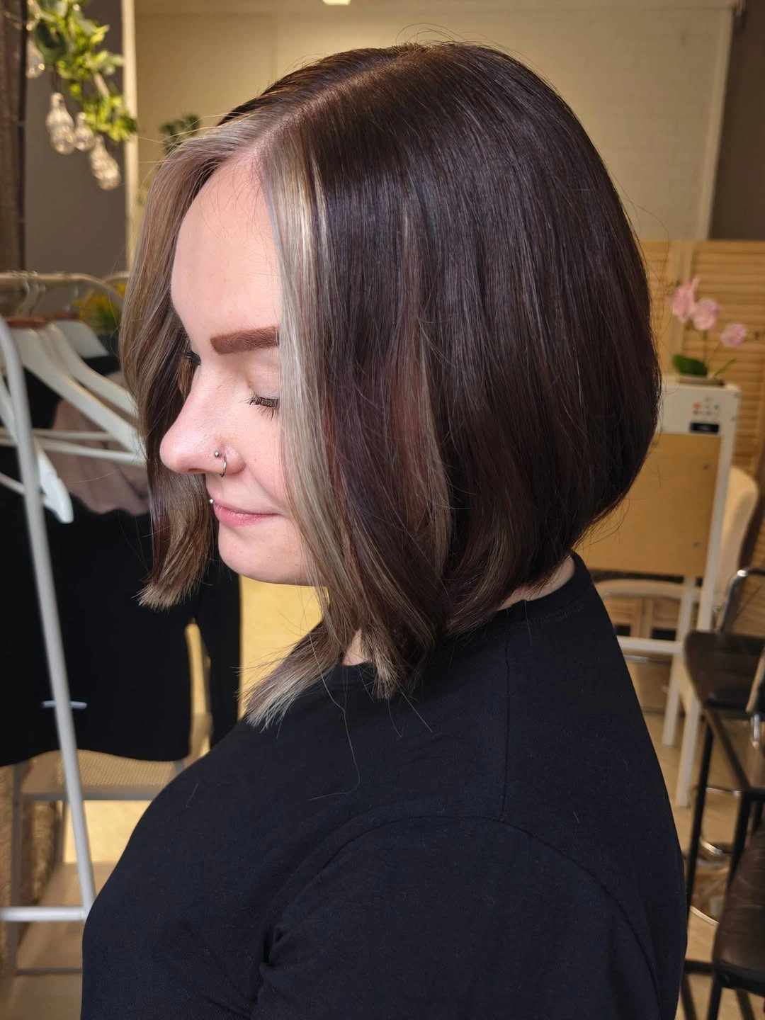 Brunette angled bob with pale streak and longer front strands