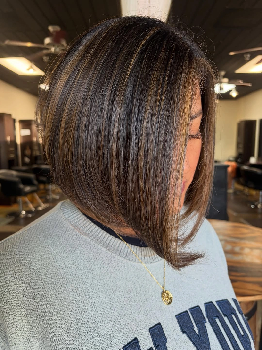 Dark brunette angled bob with caramel face-side ribbons