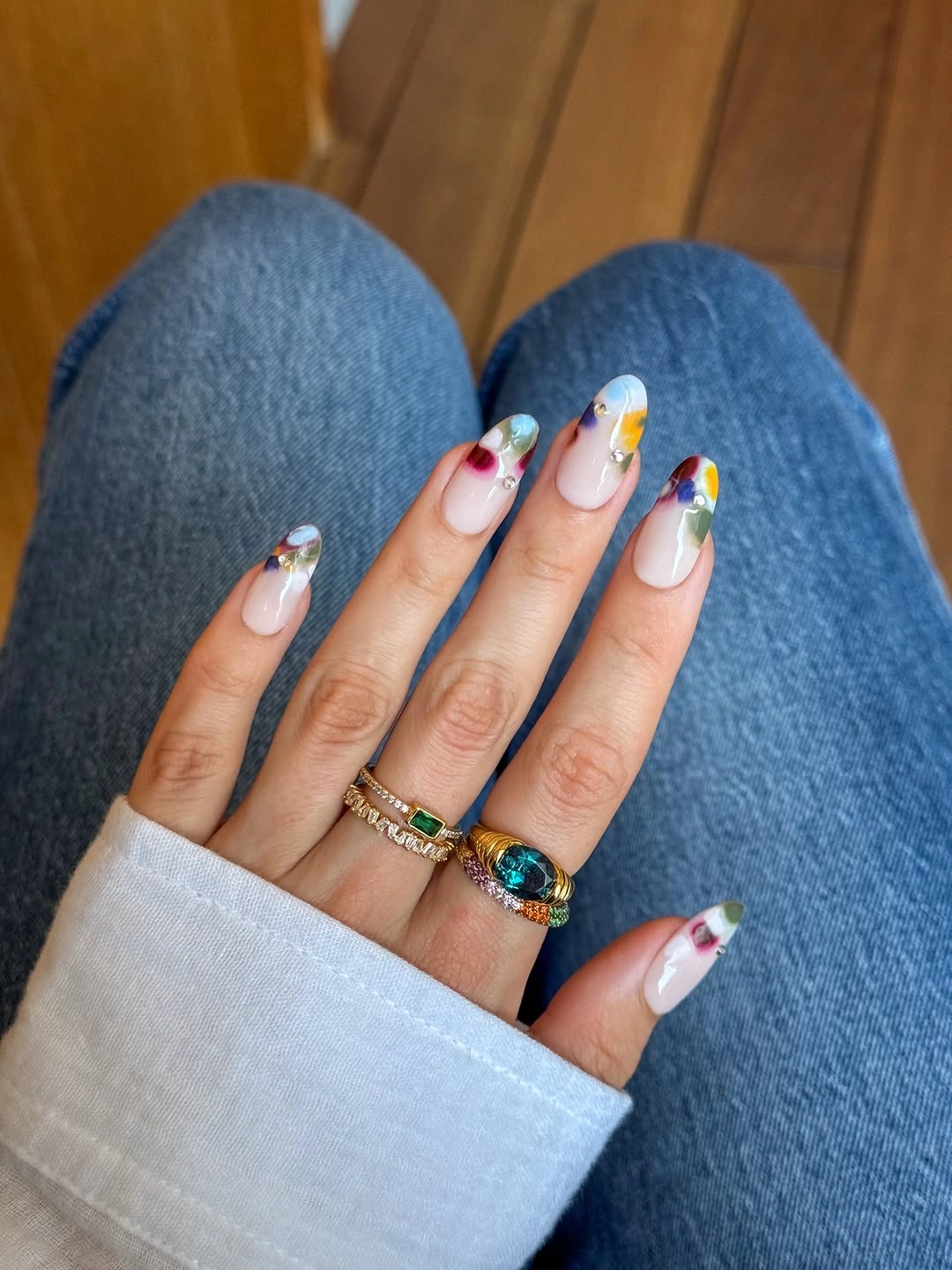 Short almond nails with compact multicolor corner and tip accents