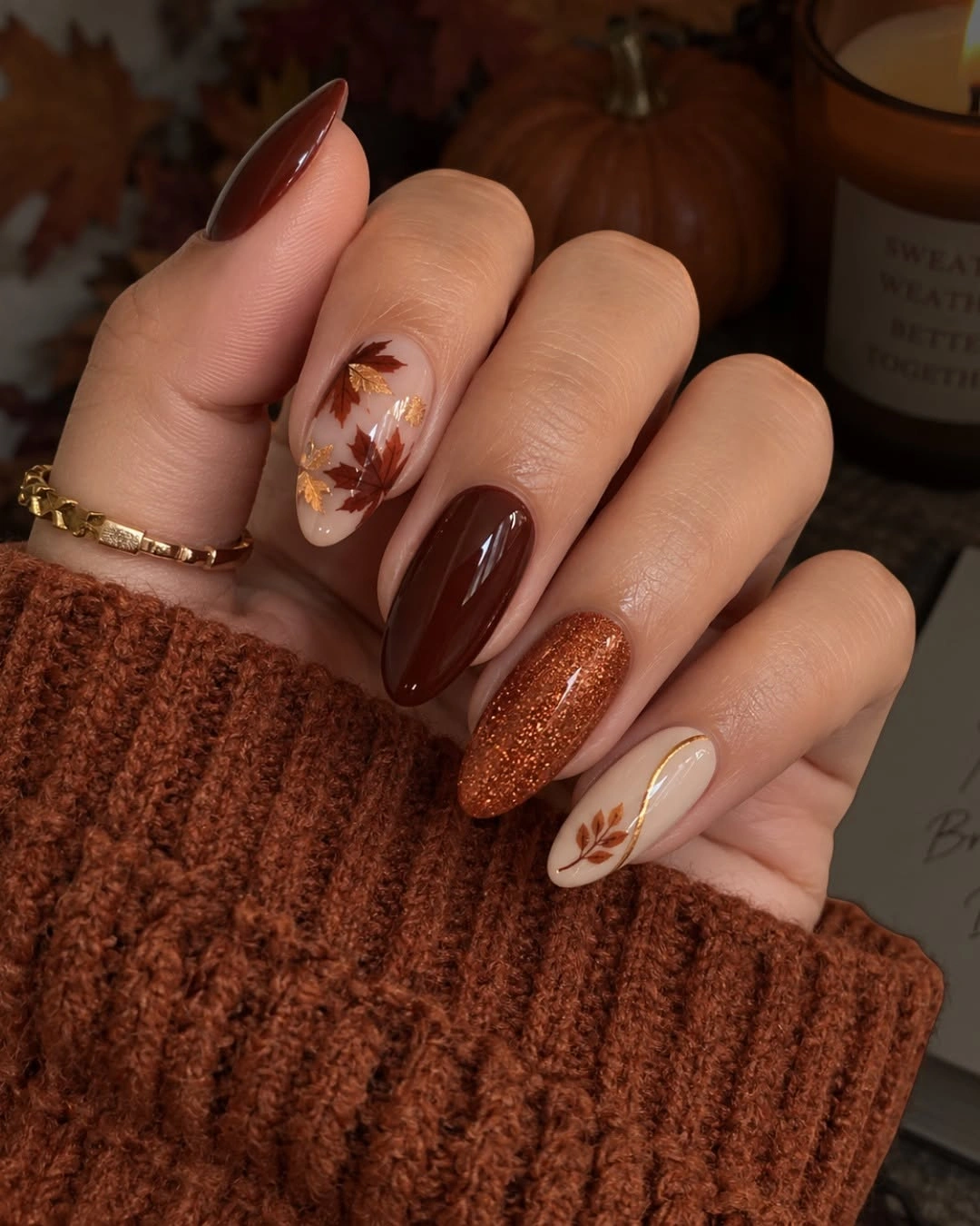 Long brown almond nails with copper shimmer and botanical details
