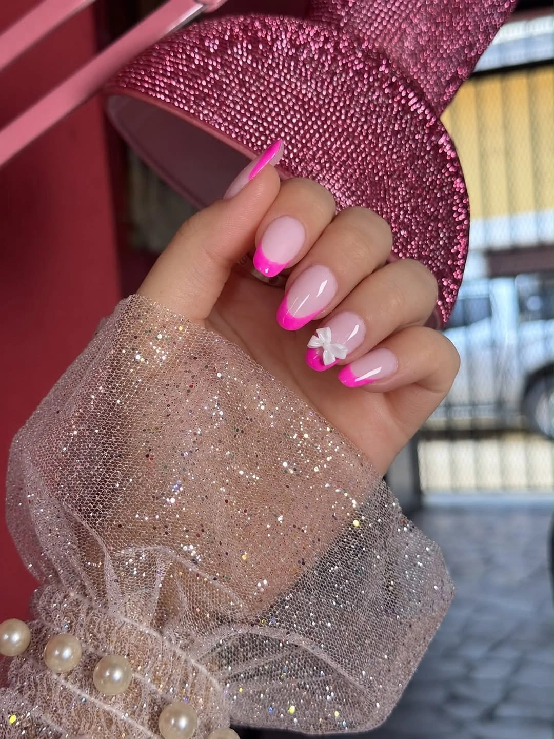 Pink almond nails with hot pink French tips and bow