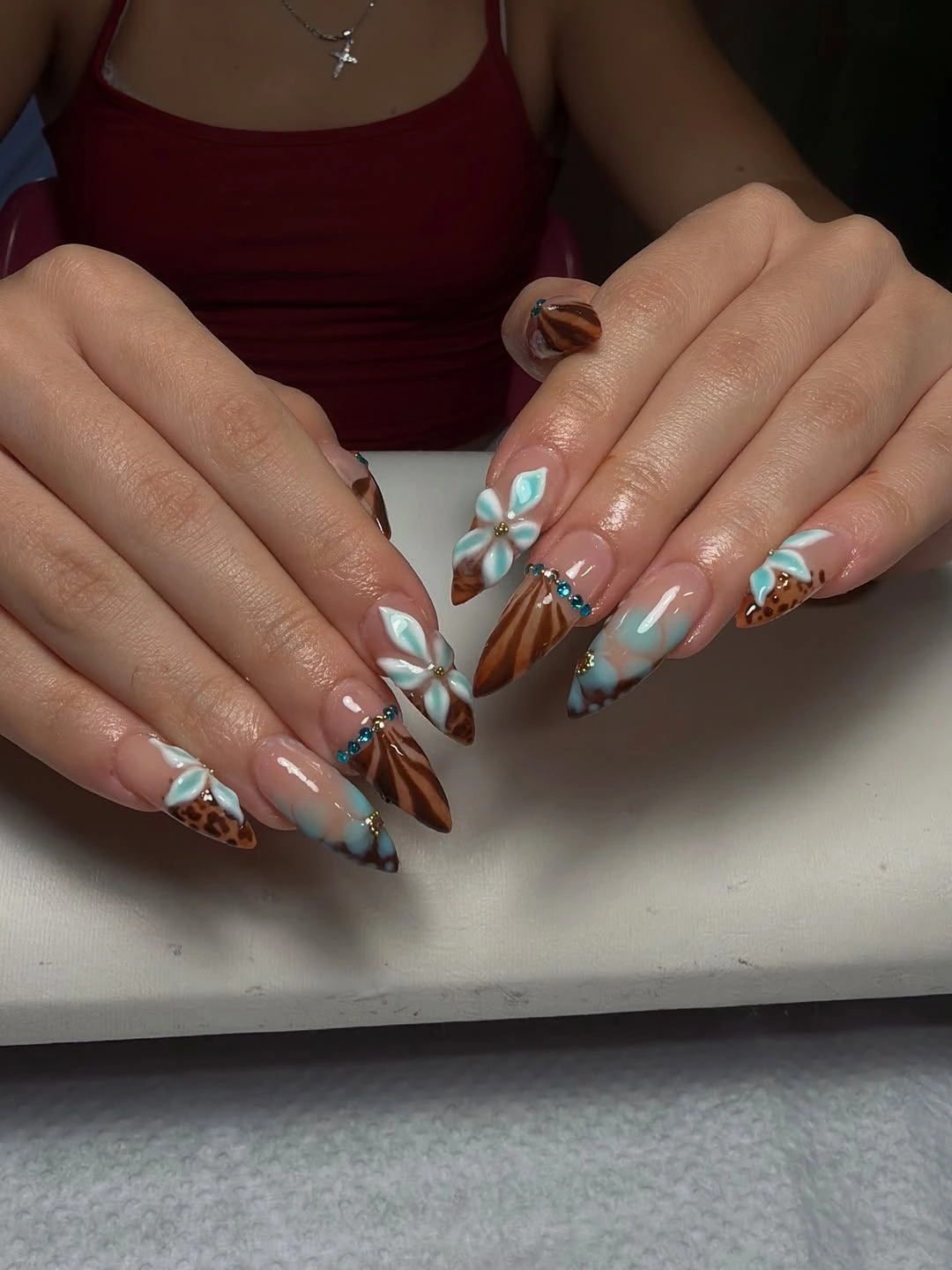 Long almond nails with brown turquoise and white floral details