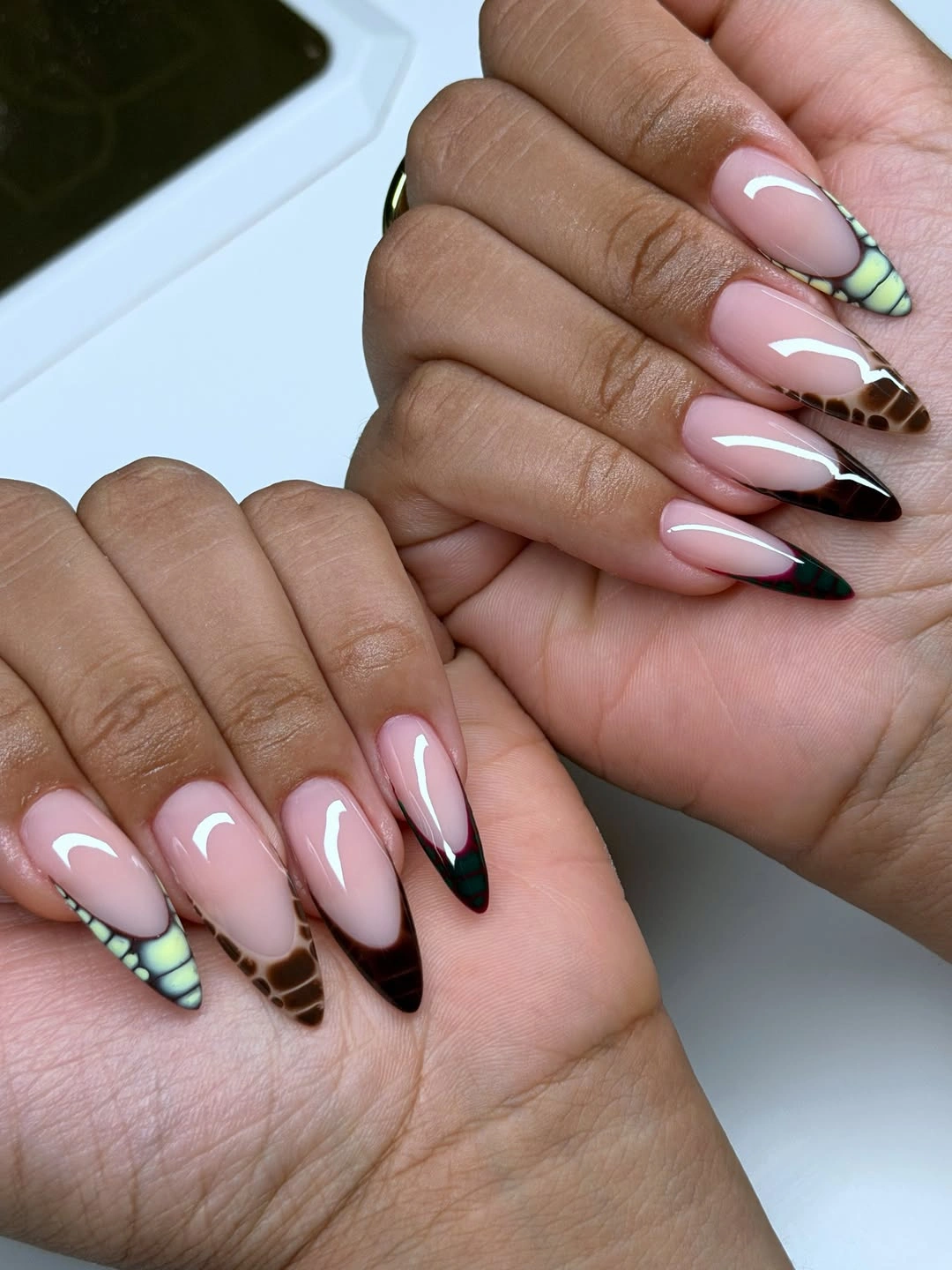 Long pink almond nails with brown green and checked tips