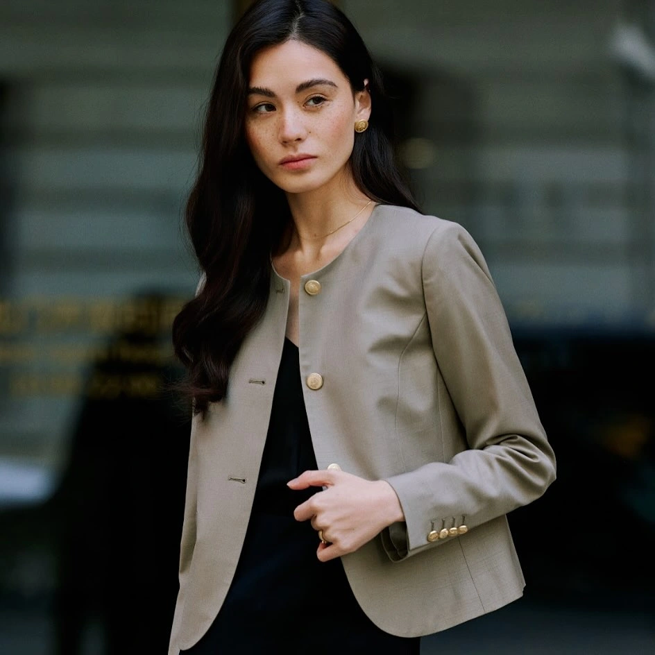 Gray cropped button jacket paired with dark tailored trousers