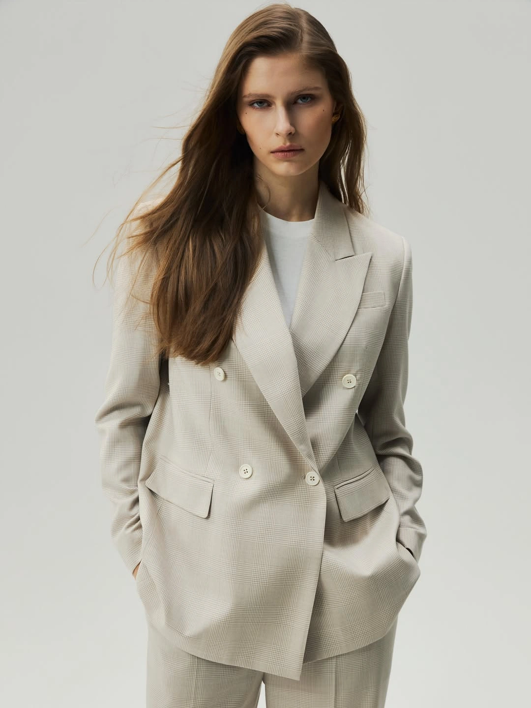 Light beige double-breasted blazer and trousers over white top