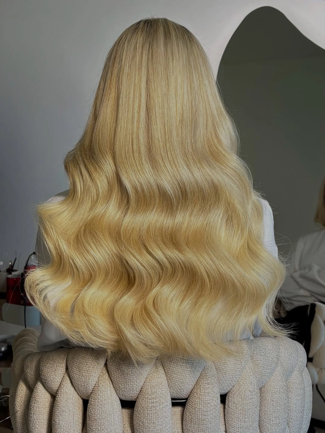 Back view of long golden blonde waves with sculpted lower bends