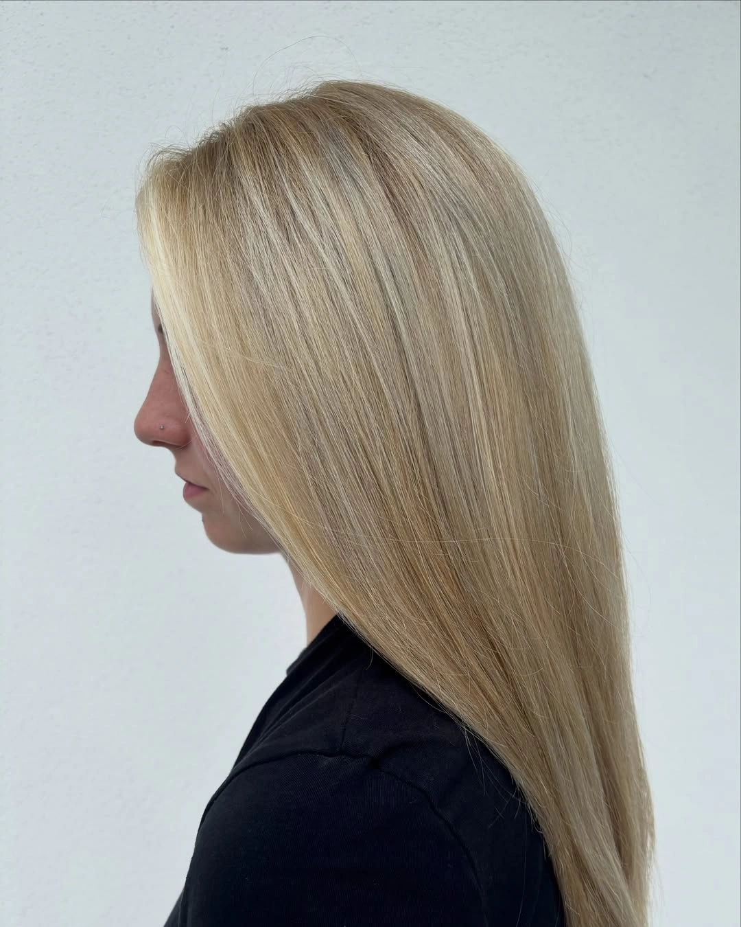 Side profile of long straight dark blonde hair with tapered ends