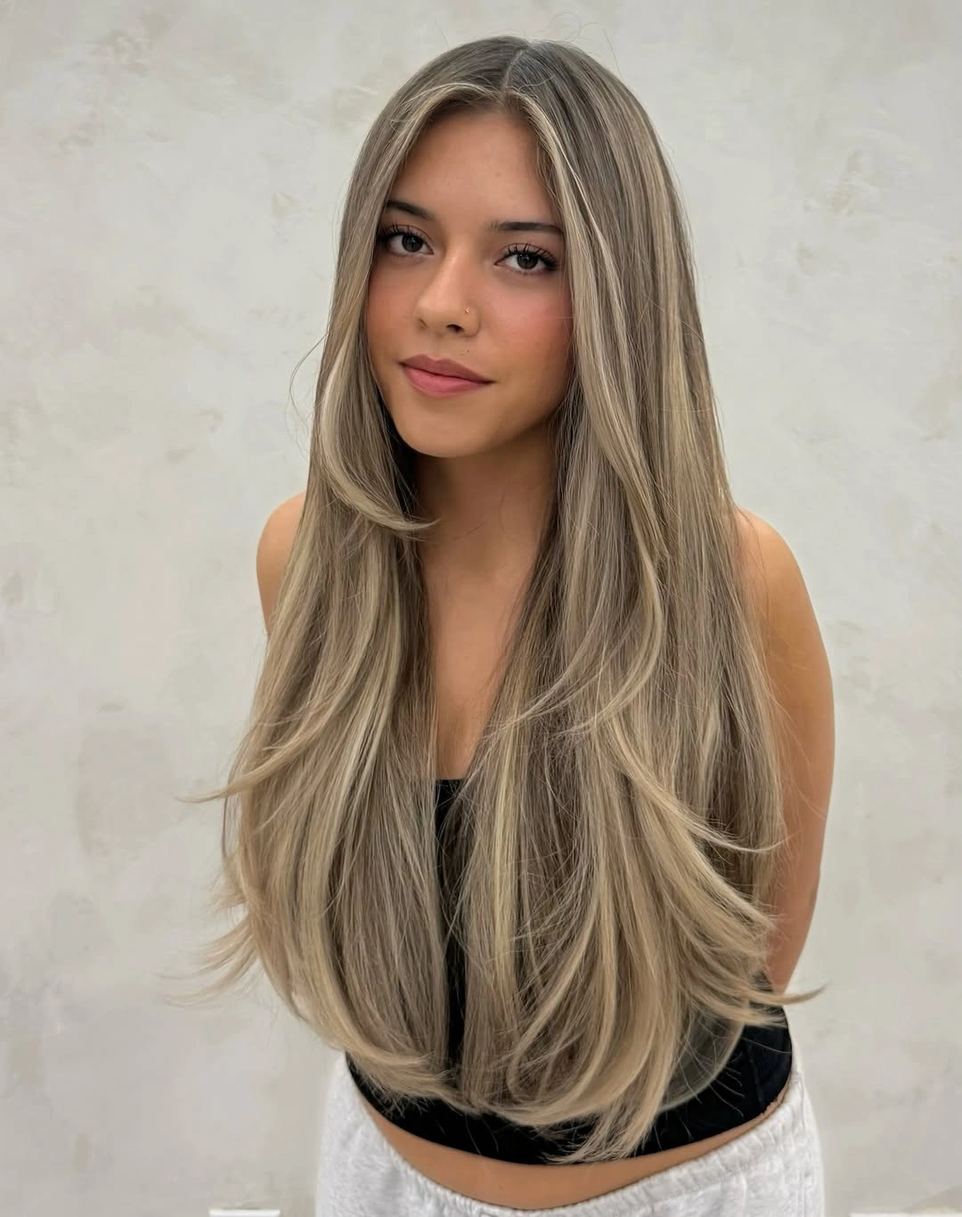 Very long dark blonde layered hair with pale face-framing ribbons
