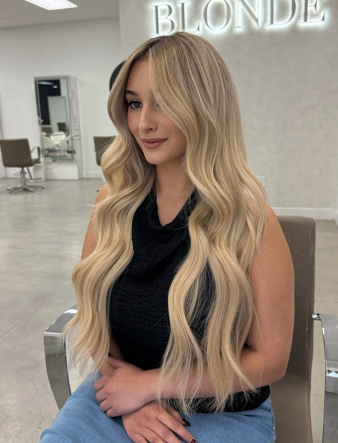Very long creamy blonde waves with center-parted face frame