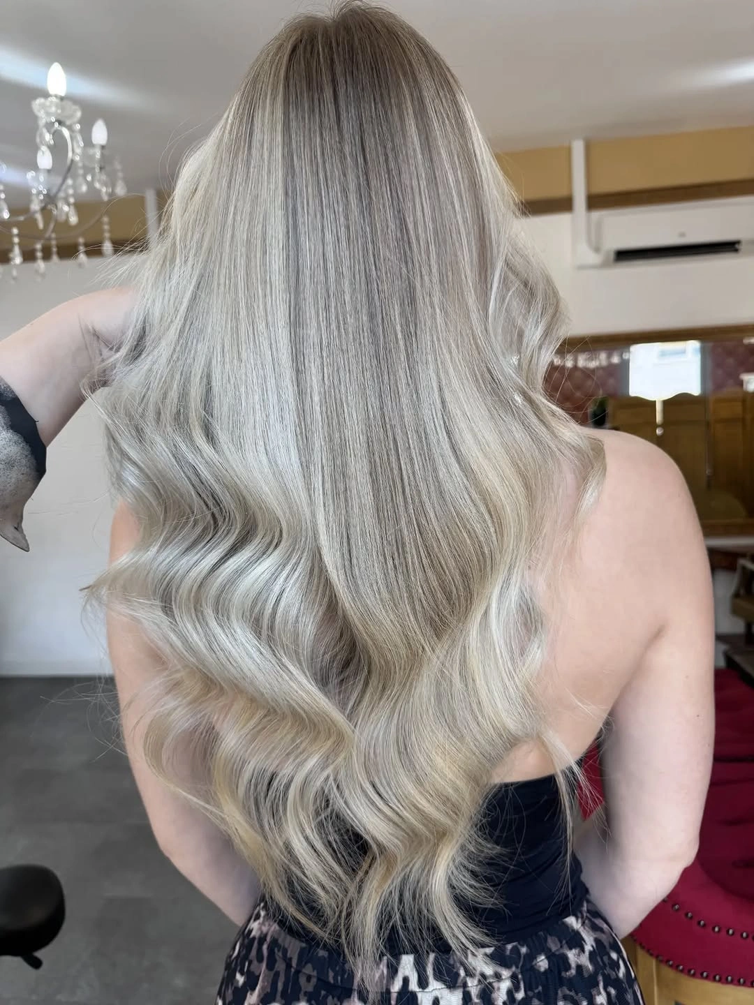 Long icy ash blonde waves with muted roots and silver-beige lengths