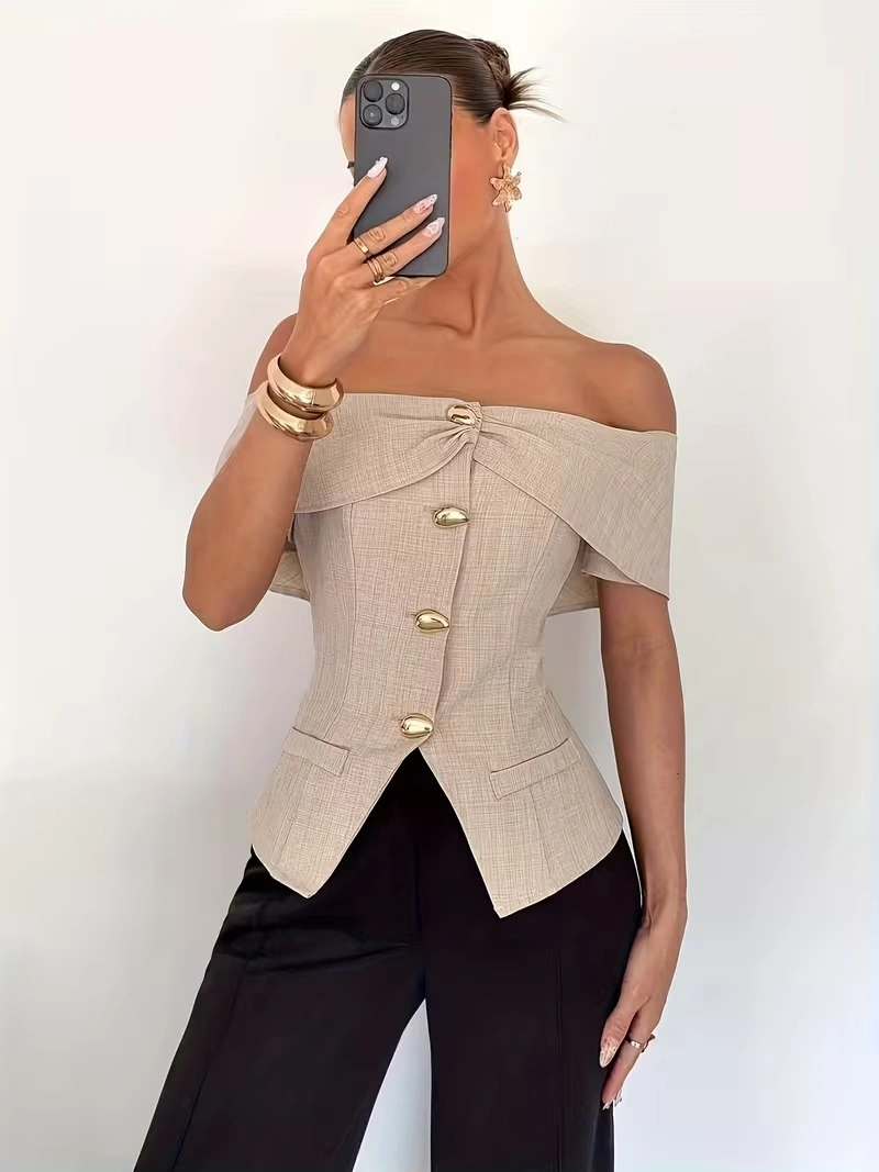 Beige sleeveless top black trousers dark handbag and gold buttons