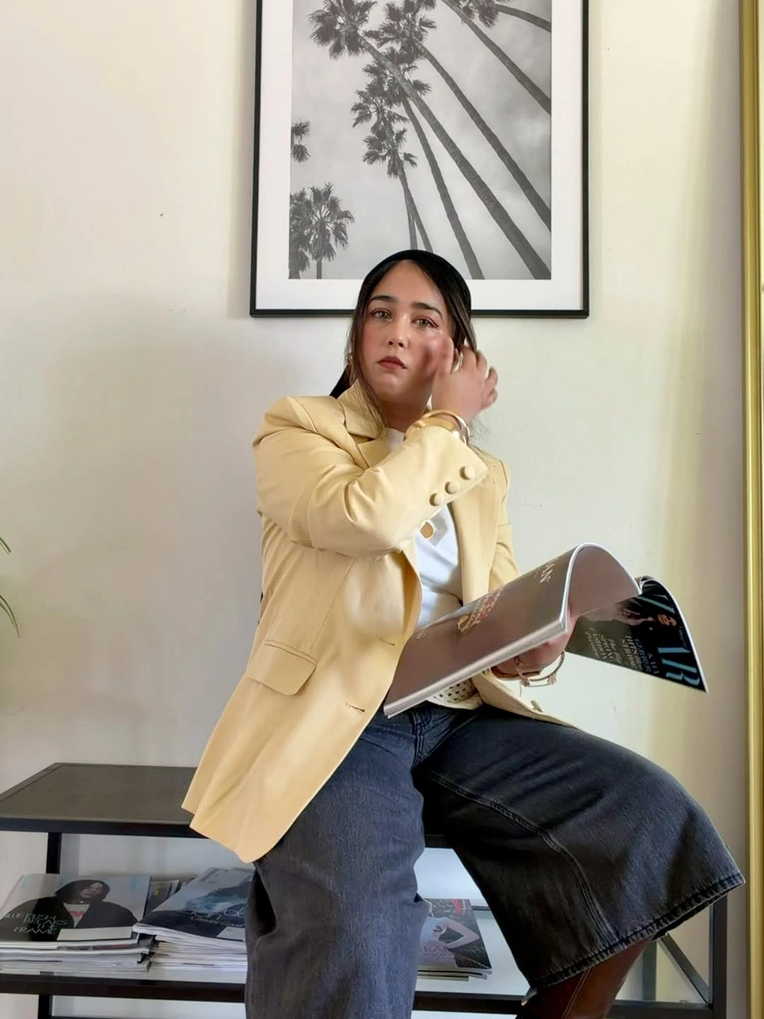 Yellow blazer light top cropped jeans and open magazine
