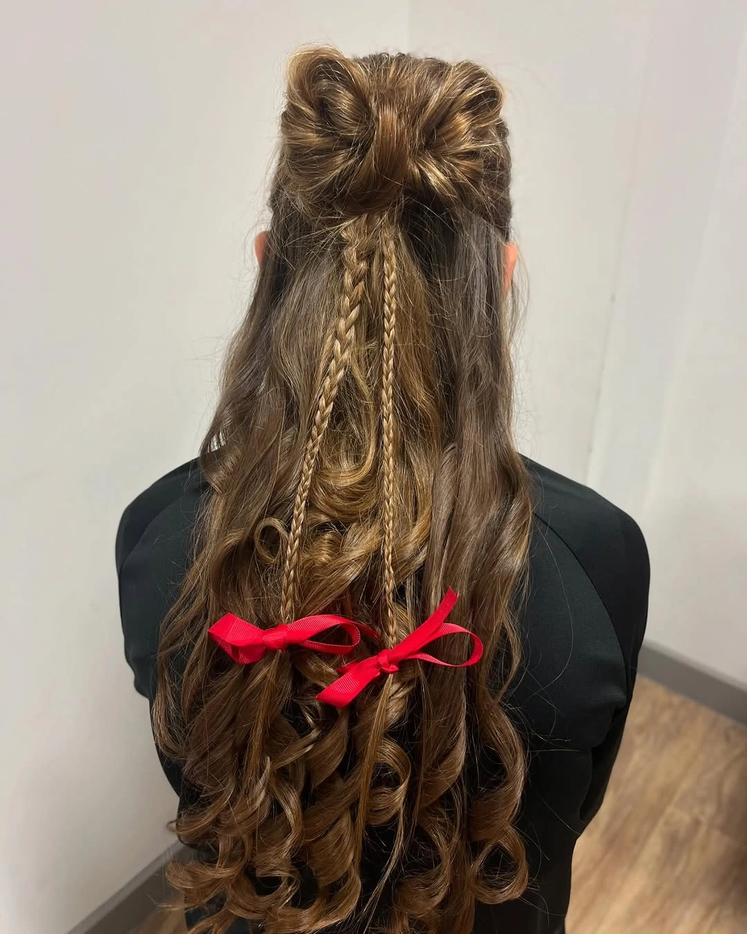 Long brown hair with braids red ribbons and curled ends