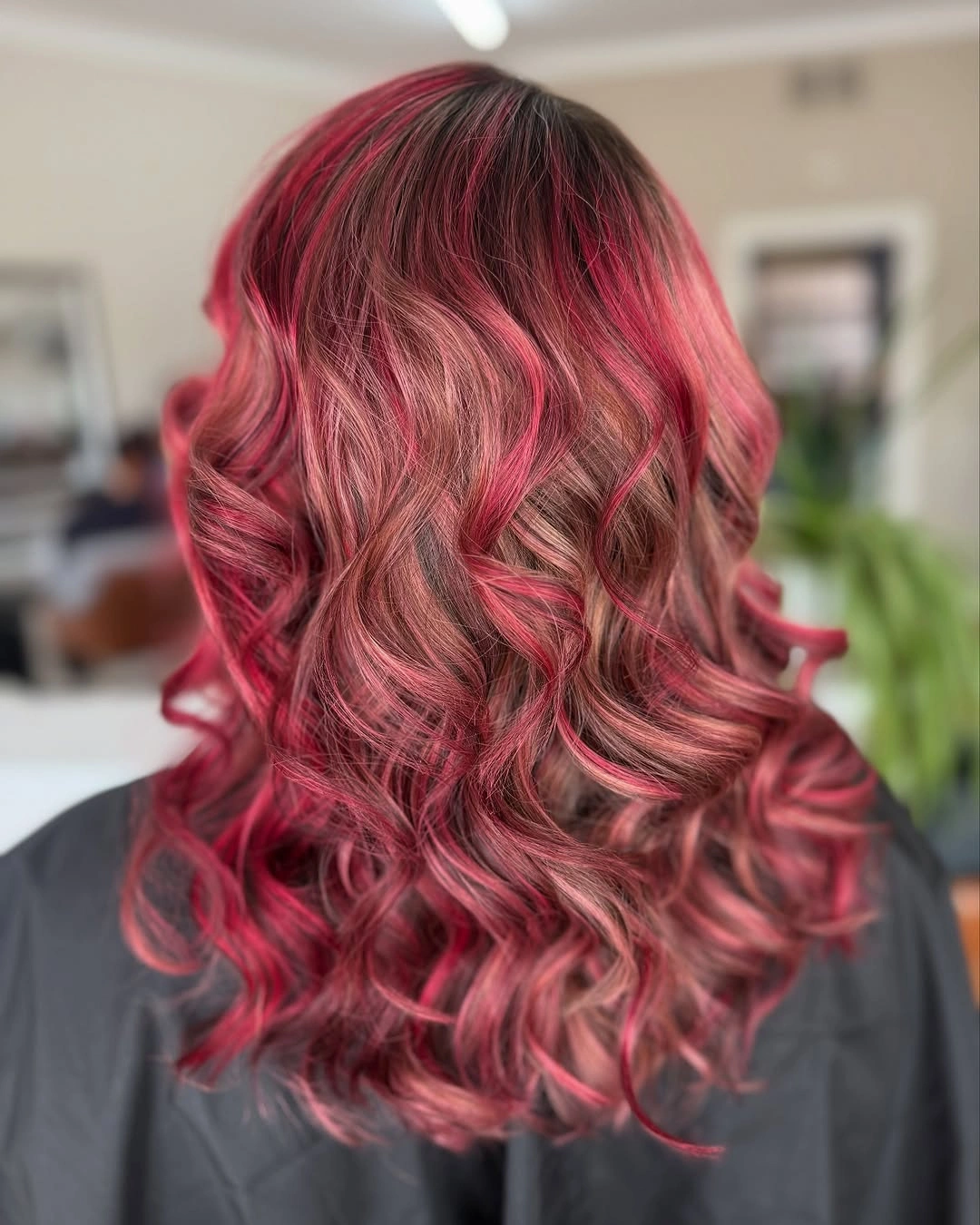 Red-pink medium-long hair with broad layered curls