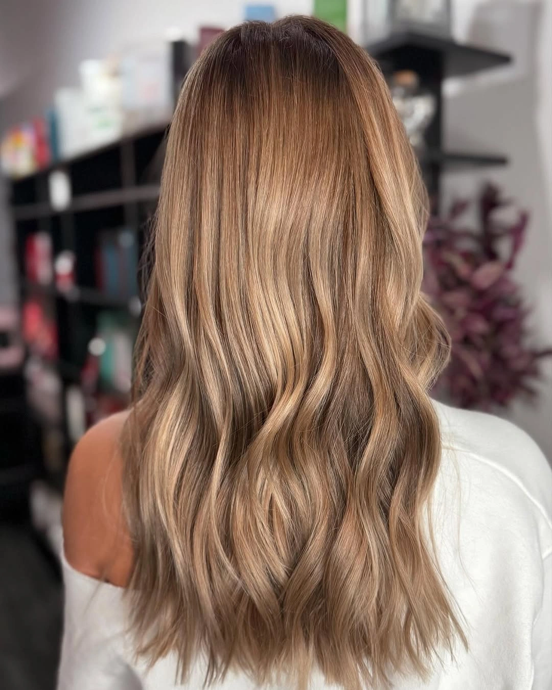 Long light brown hair with subtle lower waves