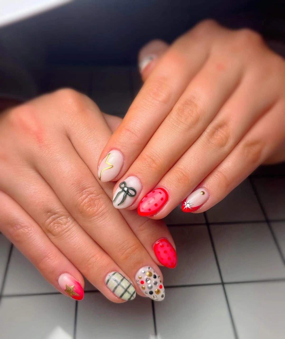 Short red and pale nails with bow, grid, dots, and studs