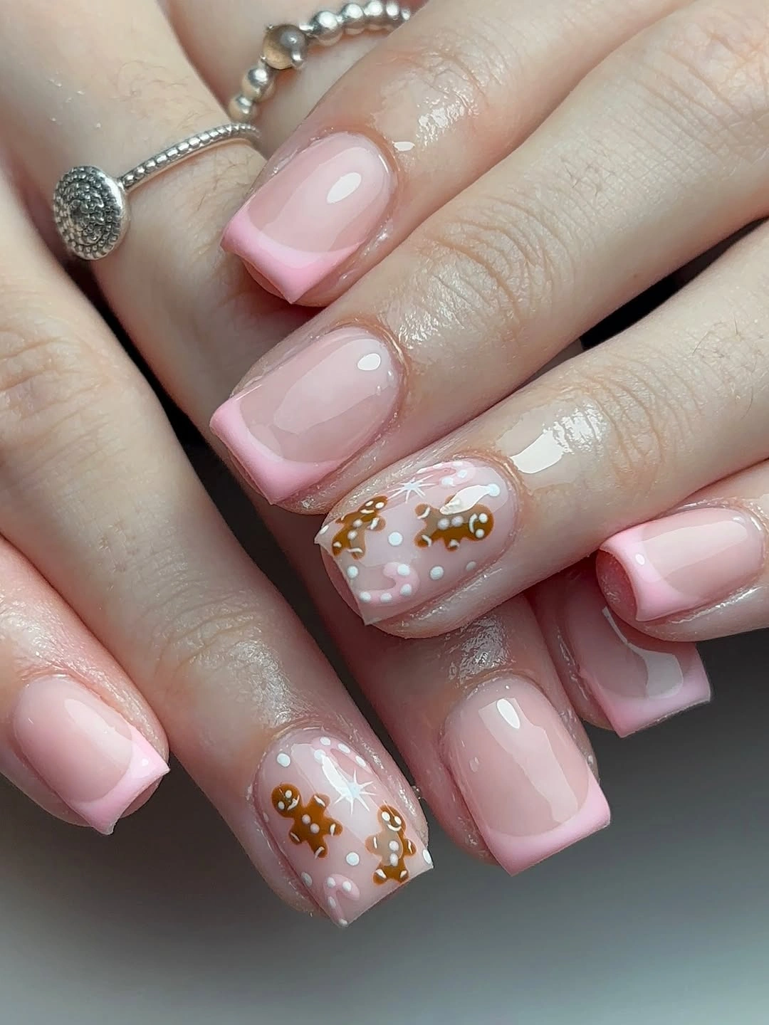 Short square pink French nails with gingerbread and white details