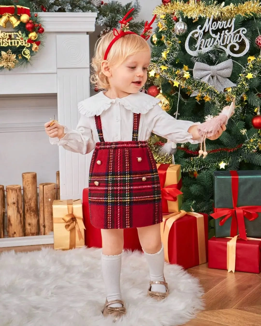 Child wears plaid suspender skirt with white ruffled blouse