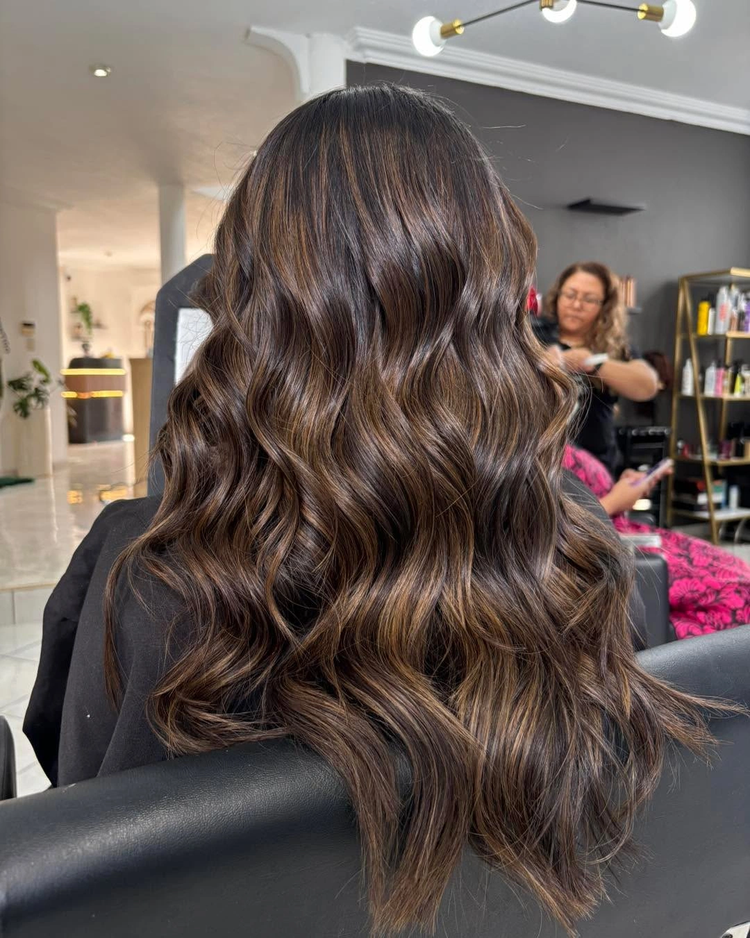 Back view of brunette waves with soft caramel ribbons