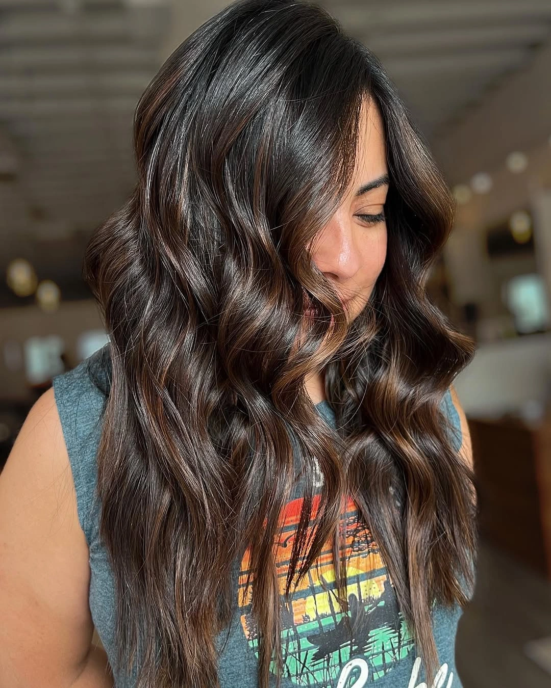 Long glossy brunette waves with caramel ribbons