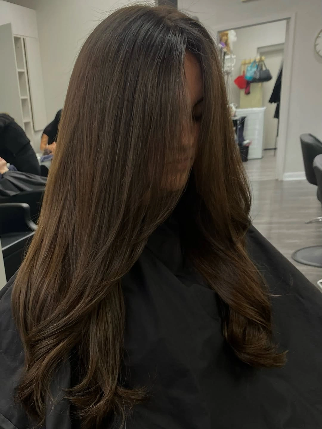 Long smooth brunette layers with softly curled ends