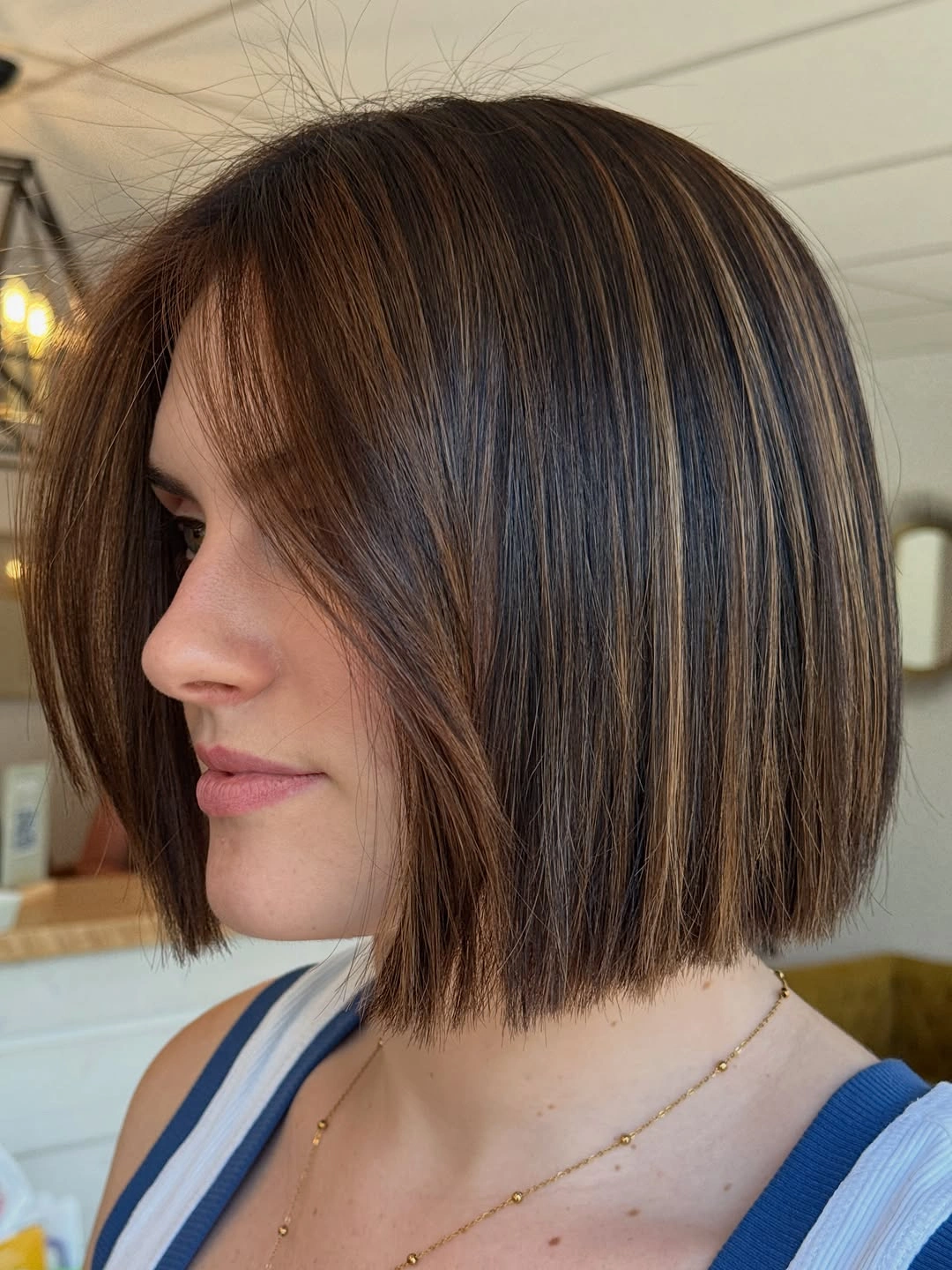 Short blunt brunette bob with fine beige streaks